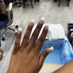 Wisteria Nails & Spa - Next to my nails and behind my hand I had white nail Polish that she had to remove! And blue chrome on cuticle!