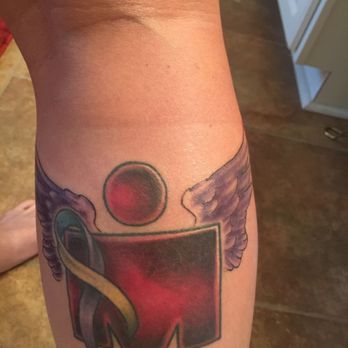 Texas Body Art - Converted Ironman tattoo to the full M Dot (140.6 miles) covered the 70.3 and added purple wings for being a survivor of domestic violence - Tattoo Near Me - Houston, Texas Texas Body Art - Converted Ironman tattoo to the full M Dot (140.6 miles) covered the 70.3 and added purple wings for being a survivor of domestic violence - Tattoo Near Me - Houston, Texas