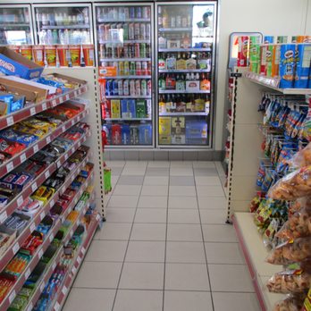 Chevron - a grocery store aisle filled with food - Gas Stations Near Me - Lake Forest, California