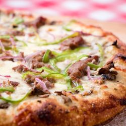 Villages Pizza - Philly Cheese Steak - Garlic butter base with juicy steak slices, fresh sliced mushrooms, double mozzarella, red onio