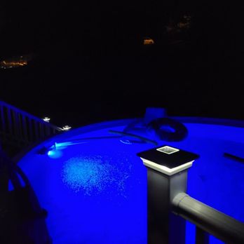 Sirin Construction - a blue pool at night - General Contractors Near Me