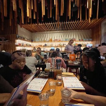 Mecha Noodle Bar - a group of people sitting at a table - Ramen Near Me - Fairfield, Connecticut Mecha Noodle Bar - a group of people sitting at a table - Ramen Near Me - Fairfield, Connecticut