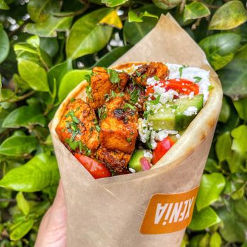 XENiA Mediterranean Kitchen - a hand holding a burrito - Mediterranean Near Me - Los Angeles, California XENiA Mediterranean Kitchen - a hand holding a burrito - Mediterranean Near Me - Los Angeles, California