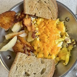The Pantry - Meat Lover's Skillet: 3 eggs scrambled, bacon, ham, sausage, cheddar cheese, home fries, and rye toast.