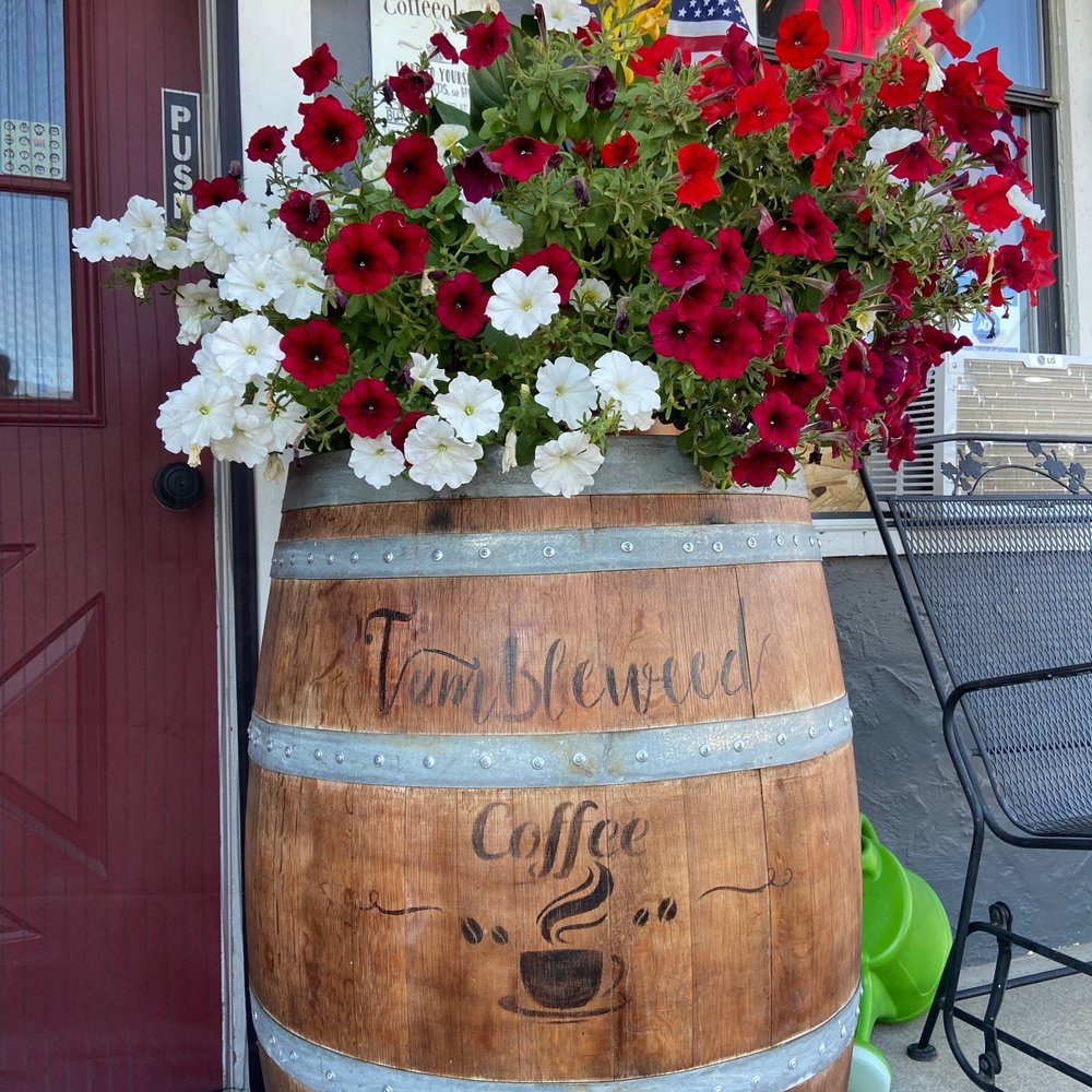 a wooden barrel with flowers in it