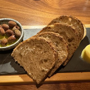 Wild Blue Restaurant + Bar - House sourdough, butter with evoo and taggiasca olives - Seafood Near Me - Whistler, British Columbia Wild Blue Restaurant + Bar - House sourdough, butter with evoo and taggiasca olives - Seafood Near Me - Whistler, British Columbia
