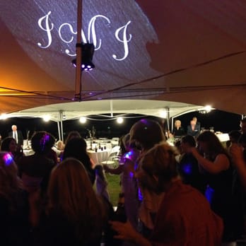 Murray and Mike's Catering - a group of people dancing under a tent - Caterers Near Me Murray and Mike's Catering - a group of people dancing under a tent - Caterers Near Me