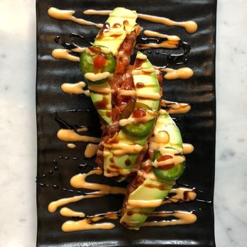 Sushi 101 - an avocado covered in sauce on a black plate - Japanese Near Me - Los Angeles, California Sushi 101 - an avocado covered in sauce on a black plate - Japanese Near Me - Los Angeles, California
