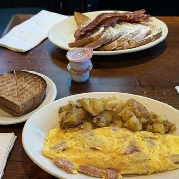 Mena's Palace - Andouille sausage omelette and brioche French toast. - Breakfast & Brunch Near Me - New Orleans, Louisiana Mena's Palace - Andouille sausage omelette and brioche French toast. - Breakfast & Brunch Near Me - New Orleans, Louisiana