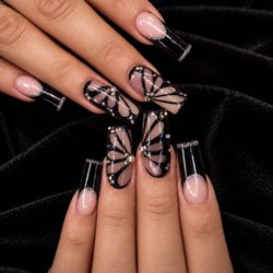 Pure Nails Spa - Where elegance meets a little drama.Butterfly details, crystal sparkle, and a timeless black finish.
