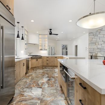 AGC Home Remodeling - Modern kitchen with flat-panel cabinets, high-end appliances, pendant lights, and multicolor marble floors in Austin, TX - General Contractors Near Me - Austin, Texas AGC Home Remodeling - Modern kitchen with flat-panel cabinets, high-end appliances, pendant lights, and multicolor marble floors in Austin, TX - General Contractors Near Me - Austin, Texas