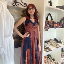 A beloved customer looking very satisfied with her new dress, from us!