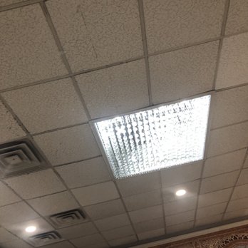 Dera - Beautifully decorated with a chandelier - Ceiling features a fluorescent light panel, recessed lights, and air vents, with decorative wall paneling below. - Pakistani Near Me - Springfield, Virginia