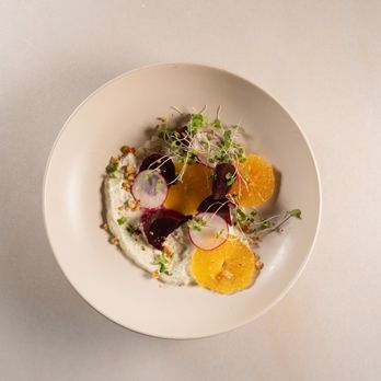 Pitanga - a plate of food with oranges and radishes - Comfort Food Near Me - Brooklyn, New York
