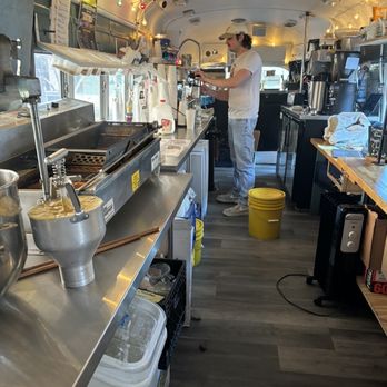 Donutology - a man preparing food in a commercial kitchen - Donuts Near Me - Kansas City, Missouri