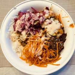 BIBIBOP Asian Grill - Korean beef bowl with rice and noodle base, kimchi, carrot, cabbage, yum yum sauce