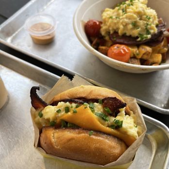 Eggdose - Scrambled Sandwich with avocado and bacon. In the back is the Eggdose Bowl with steak. - Breakfast & Brunch Near Me - Orlando, Florida