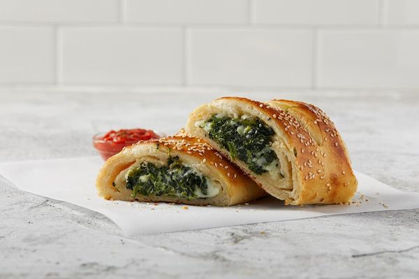 Photo of Sbarro - Santa Ana, CA, US. a close up of a sandwich with spinach and cheese