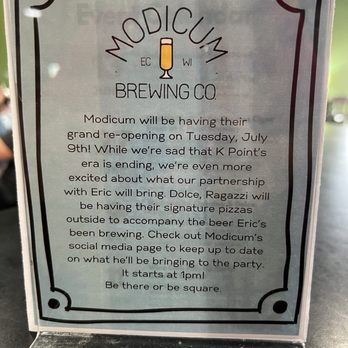 Modicum Brewing - A printed sign details Modicum Brewing Co.'s grand re-opening event on Tuesday, July 9th, featuring Eric's signature pizzas and social media updates. - Breweries Near Me - Eau Claire, Wisconsin