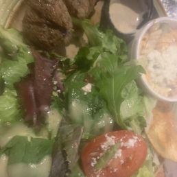 Grilled beef with a greek salad and pasta salad Grilled beef with a greek salad and pasta salad