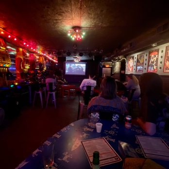 Art Bar - people sitting at tables in a dimly lit room - Bars Near Me - Columbia, South Carolina