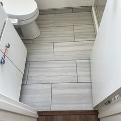 Bathroom with tile baseboards by Jerry