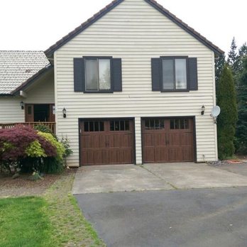 Northwestern Overhead Door - Carrige style doors with walnut wood color. - Garage Door Services Near Me - Gresham, Oregon