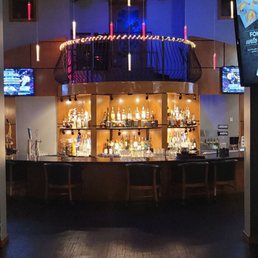 a bar with a large screen tv a bar with a large screen tv