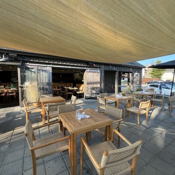 Cinder Restaurant - Seating underneath the outdoor shade canopy looking into the restaurant - Breakfast & Brunch Near Me - Westerly, Rhode Island