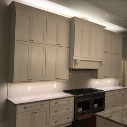 French Quarter Facades Kitchen & Bath - White shaker stacked cabinets