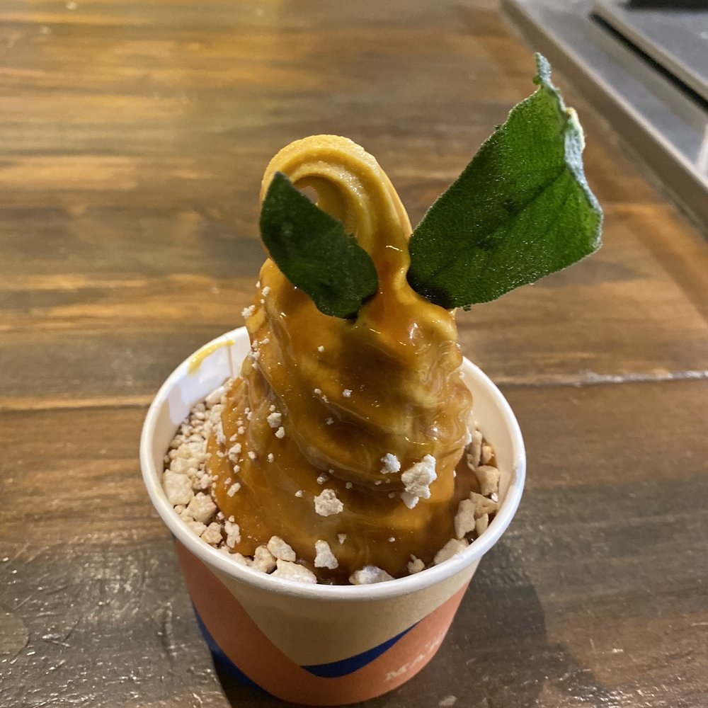 Made by Marcus - Drunken Pumpkin - amoretti cookie crunch, whiskey caramel sauce, with fried sage leaves - Coffee & Tea Near Me - Calgary, Alberta Made by Marcus - Drunken Pumpkin - amoretti cookie crunch, whiskey caramel sauce, with fried sage leaves - Coffee & Tea Near Me - Calgary, Alberta