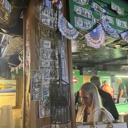 Bud's Pub - Post a dollar with your name to the wall, ask the bartender for tape and a sharpie.