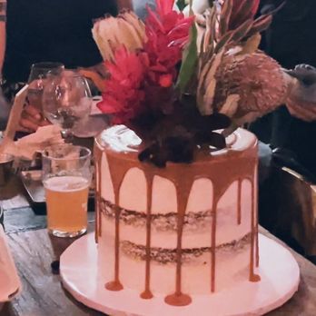 Cakes By Jess - Semi-naked carrot cake with drip and real flower toppers. - Bakeries Near Me Cakes By Jess - Semi-naked carrot cake with drip and real flower toppers. - Bakeries Near Me
