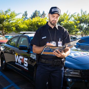 Wolfpack Protective Services - Wolfpack Protective Services guard checking identifications and permit entries at access points. - Security Services Near Me - Reseda, California