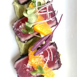 Sumac seared tuna over citrus-creamy avocado and orange supremes