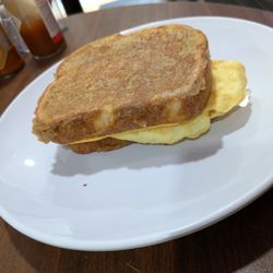 Angelita's Cafe - French toast sandwich with omelette and sausage