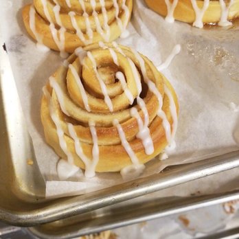 Redefined Coffee - cinnamon buns with icing on a baking sheet - Coffee & Tea Near Me - Brooklyn, New York