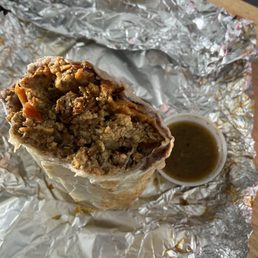 Chorizo breakfast burrito with some bomb spicy salsa on the side