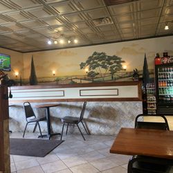 Papa Santo's Pizza - Some seating and the bottle sodas. Nice murals.
