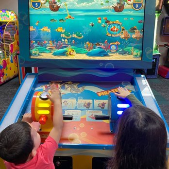 Chuck E. Cheese - two children playing a video game - Pizza Near Me - East Hanover, New Jersey