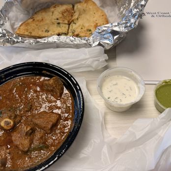 Pak Halal Kitchen - Karahi gosht (goat tomato based simmered dish), garlic naan, raita, chutney - Halal Near Me - Artesia, California Pak Halal Kitchen - Karahi gosht (goat tomato based simmered dish), garlic naan, raita, chutney - Halal Near Me - Artesia, California