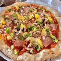 Red Pizza Sauce, Fresh cut basil, Canadian bacon, pineapple, green peppers, and mushrooms.