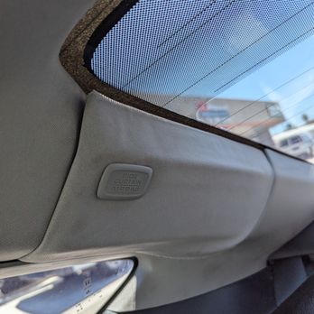 OC Windshields Auto Glass & Tint - Behind passenger seat. Dirty and failed panel attachment and loose headliner upholstery. Guess they found the side curtain airbag label - Windshield Installation & Repair Near Me - Anaheim, California OC Windshields Auto Glass & Tint - Behind passenger seat. Dirty and failed panel attachment and loose headliner upholstery. Guess they found the side curtain airbag label - Windshield Installation & Repair Near Me - Anaheim, California