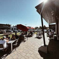 Cascade Lakes Pub on Reed Market - Main floor outdoor patio - 4 top tables, picnic tables, fire pit, walk-up bar window.