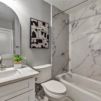 J Construction - a bathroom with a marble counter top - General Contractors Near Me J Construction - a bathroom with a marble counter top - General Contractors Near Me