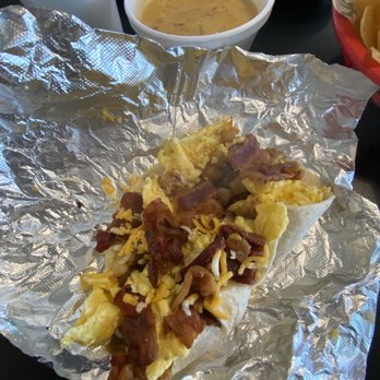 Taco Joint - Breakfast taco: bacon, beans, cheese, potatoes, egg and queso - Tacos Near Me - Dallas, Texas