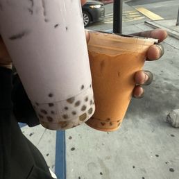 taro milk tea ( purple) thai milk tea (orange) both with golden boba.
