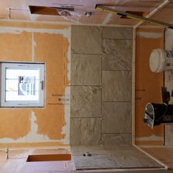 Gebhardt Homes - The beginning stages of a master custom tile shower. The orange material on the walls is the waterproofing membrane...