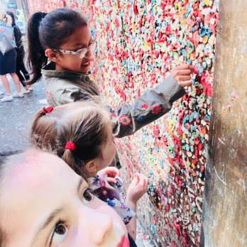 The Gum Wall - Girls trying to find a spot - Local Flavor Near Me - Seattle, Washington The Gum Wall - Girls trying to find a spot - Local Flavor Near Me - Seattle, Washington