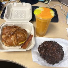 Egg, bacon and cheese croissant, apple fritter and squeezed orange juice